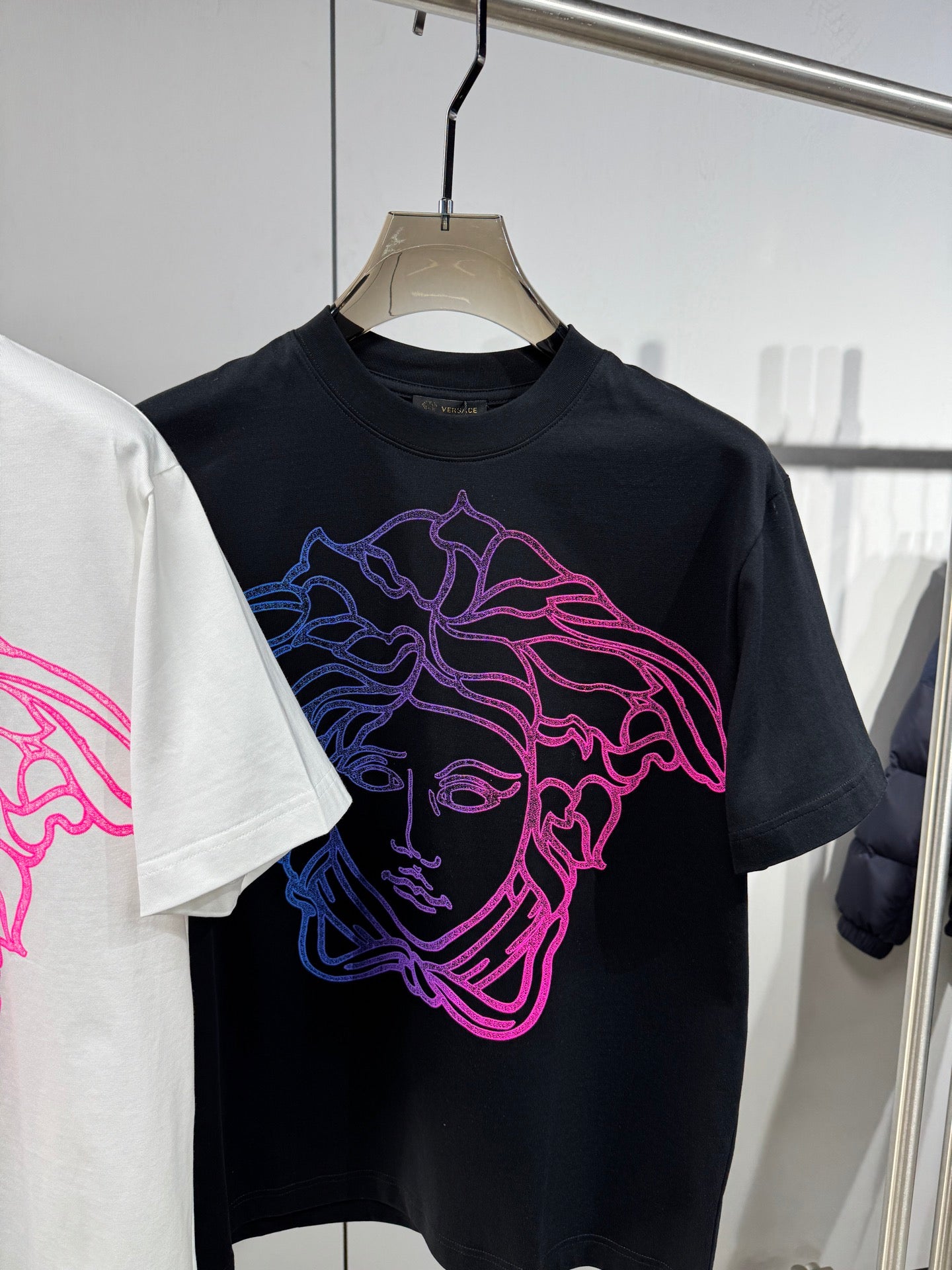 Black Versace crewneck T-shirt with neon pink and blue Medusa outline face graphic