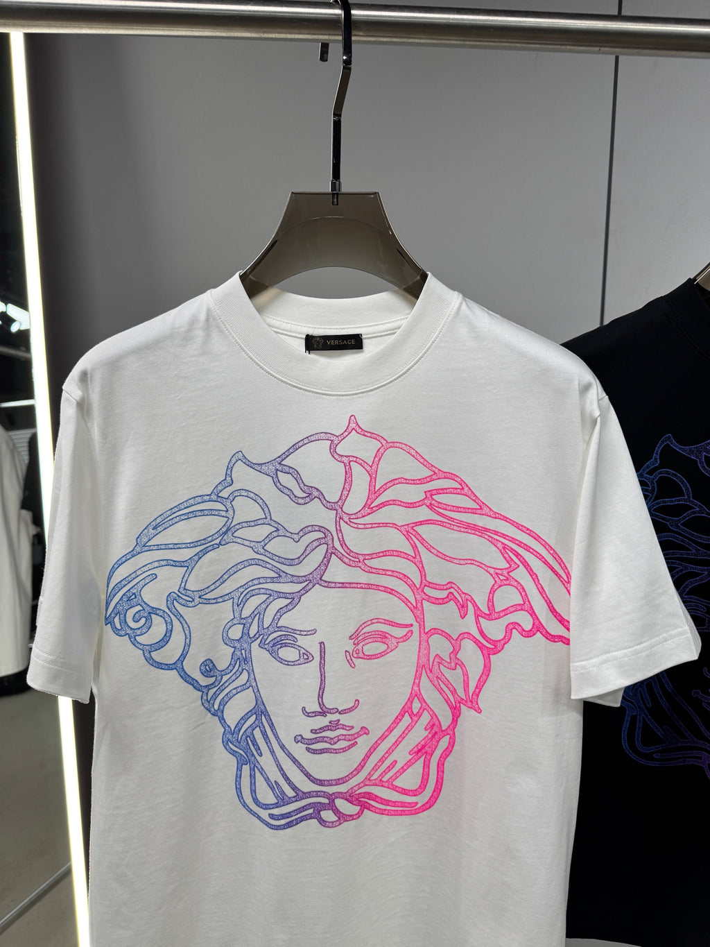 White Versace crewneck T-shirt with neon blue and pink Medusa face graphic