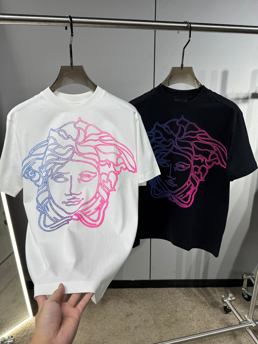 White and black Versace crewneck T-shirts with neon Medusa line-art front graphics