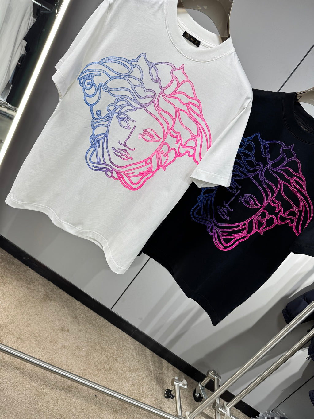 White and black Versace crewneck T-shirts with neon Medusa line-art chest graphics