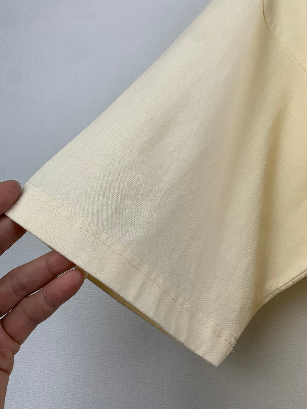 Light yellow Balenciaga T-shirt sleeve cuff with visible stitching