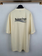 Cream short-sleeve T-shirt, back view with large Balenciaga graphic across shoulders