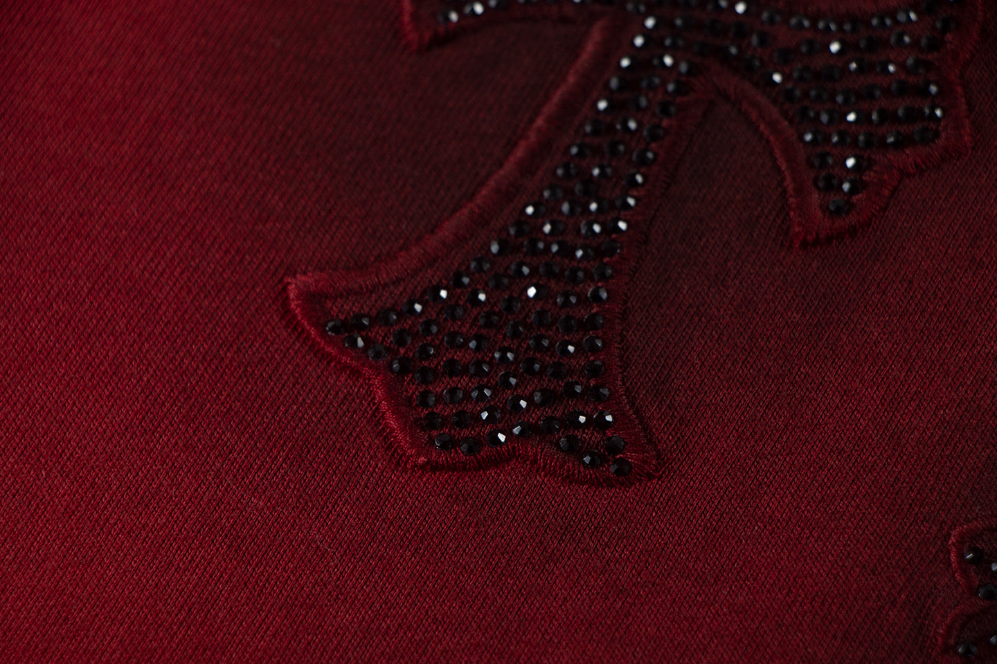 Burgundy fabric with dark jeweled star embroidery