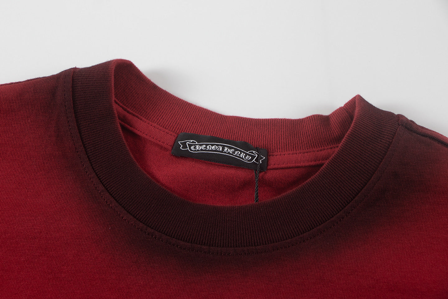 Burgundy crew-neck T-shirt collar with brand label