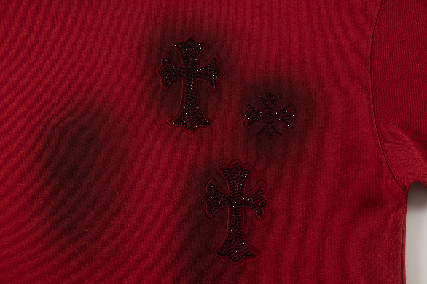 Burgundy T-shirt with dark embroidered cross and star motifs