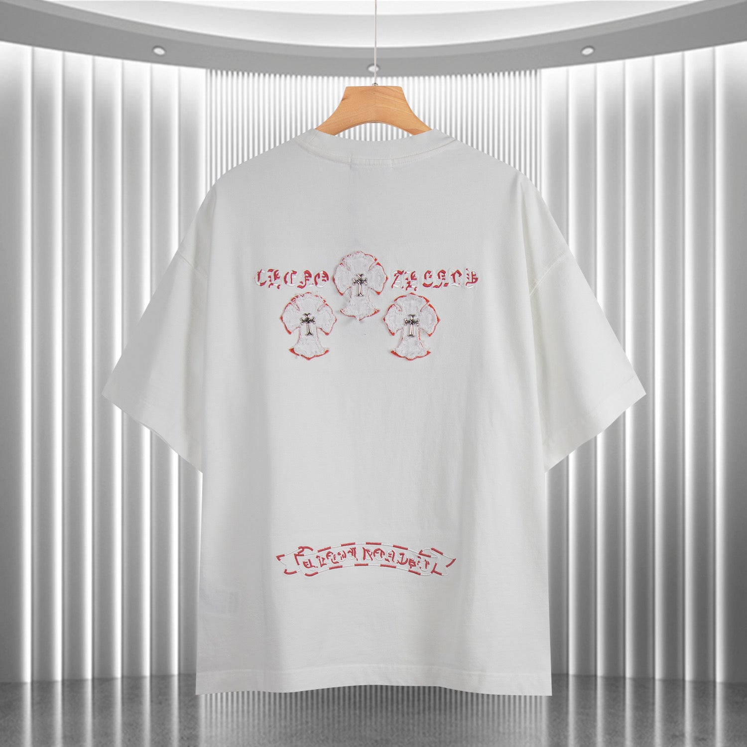 White short-sleeve T-shirt back with red text-like print and three small motif figures
