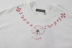 White short-sleeve T-shirt with red side embroidery and central heart-shaped cross motif