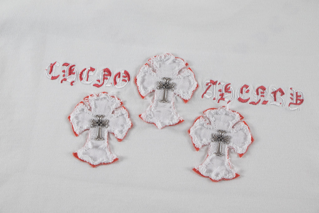 White fabric appliqué patch trio with red edges and a central cross motif
