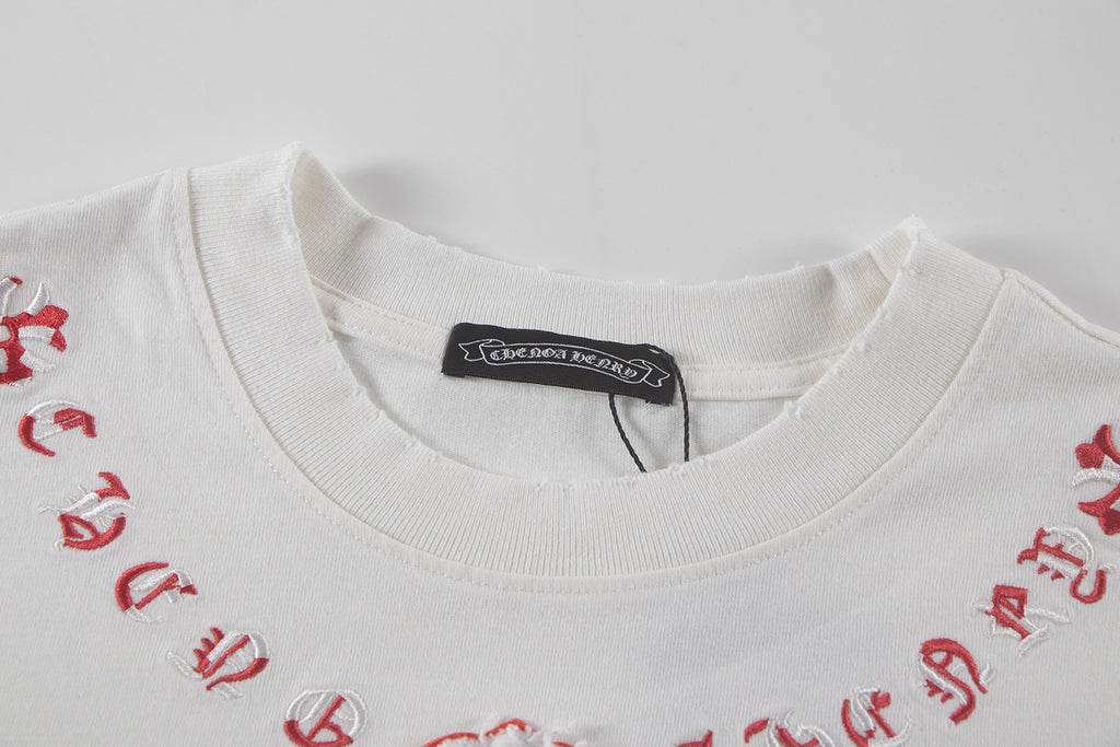 White short-sleeve T-shirt neckline with black brand label and red embroidered detailing