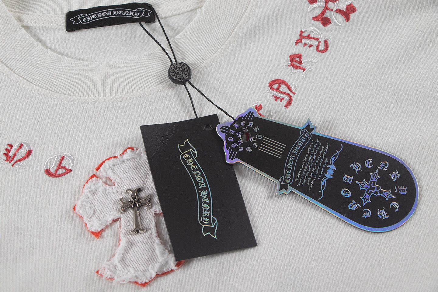 White T-shirt with embroidered heart motif plus hanging size and brand tags