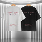 Short-sleeve T-shirt duo: white and black backs with cross motifs and graphic text