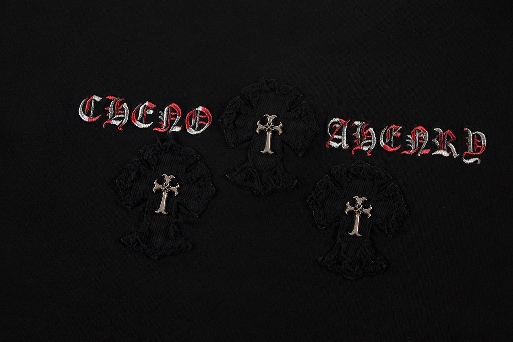 Black T-shirt front detail with red lettering and three circular cross patches