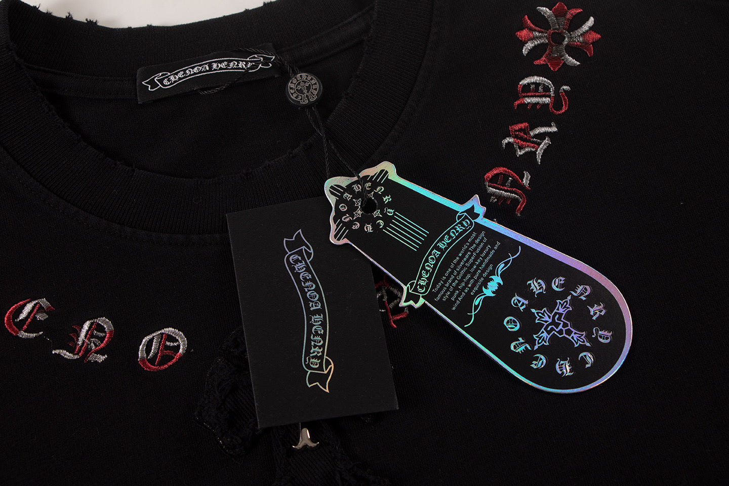 Black T-shirt with multicolor front graphic and hanging brand tag