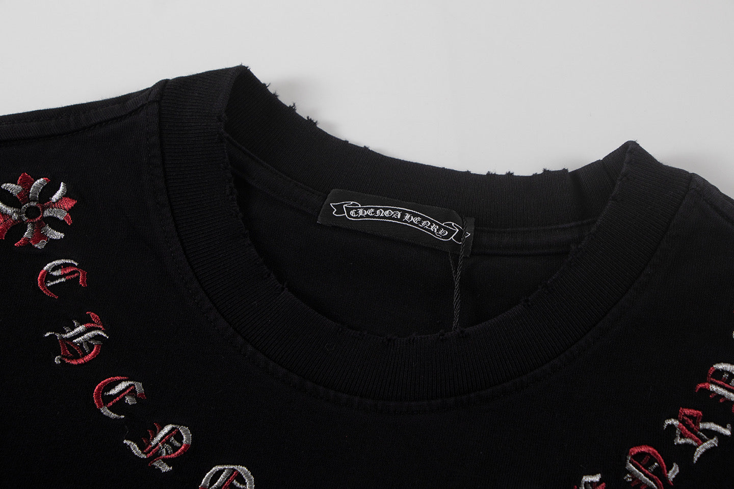 Black short-sleeve T-shirt neckline with red swirl and cross embroidery