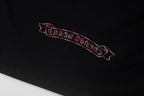 Black T-shirt front detail with red outlined banner graphic