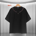 Black short-sleeve T-shirt with red script collar and small cross graphic