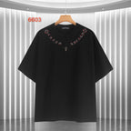Black short-sleeve T-shirt with red script collar and small cross graphic