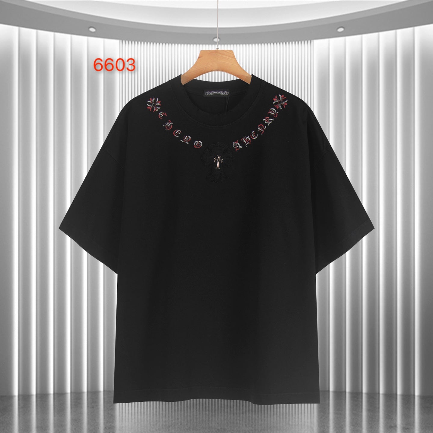 Black short-sleeve T-shirt with red script collar and small cross graphic