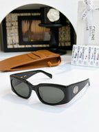 Black sunglasses with dark lenses and oval side logo badge.