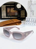 Light pink cat-eye sunglasses with gray lenses and small gold-tone emblem.