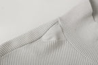 Light gray ribbed knit jacket shoulder and collar seam detail