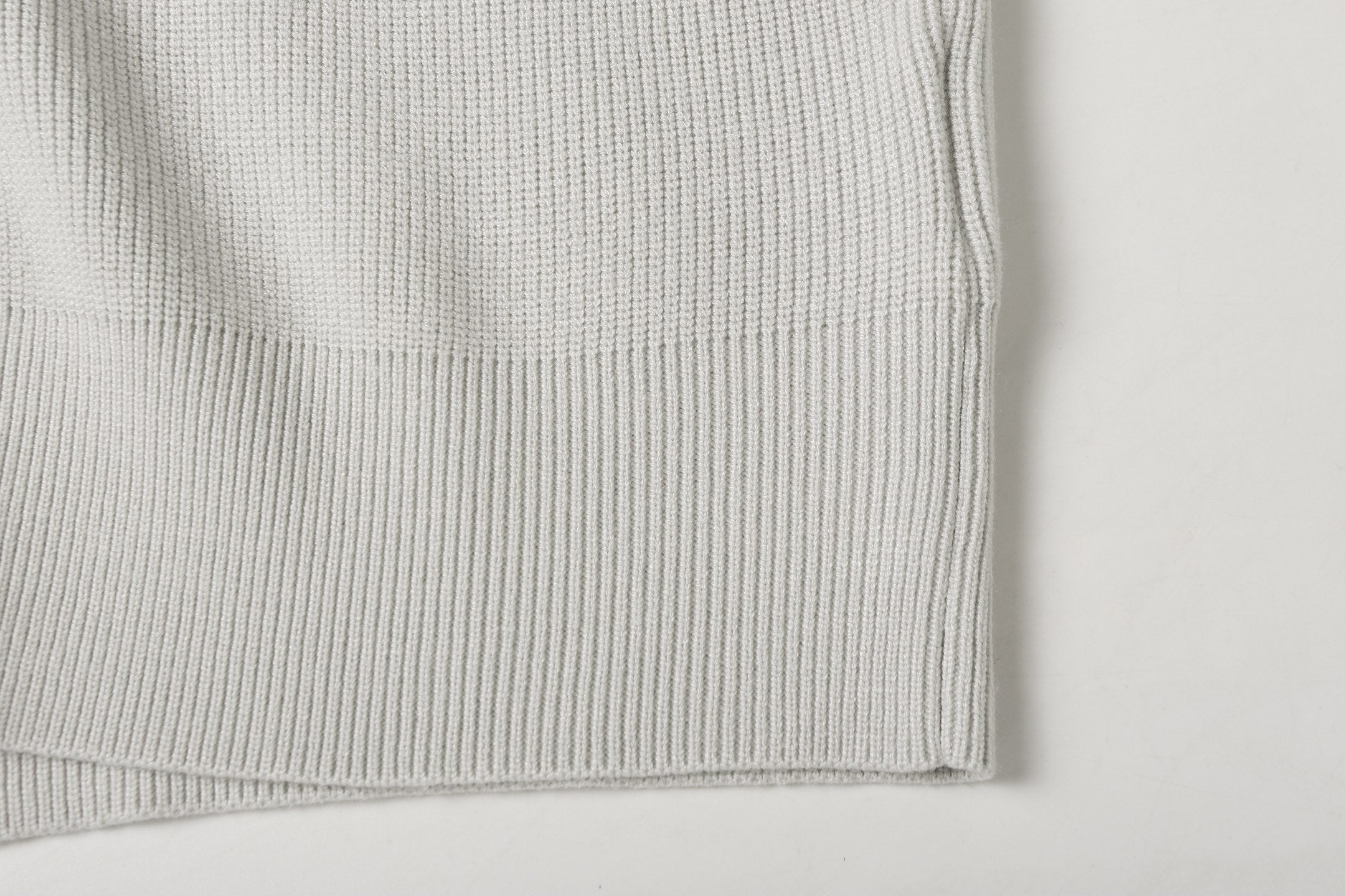 Light gray ribbed knit jacket hem cuff detail with clean edge