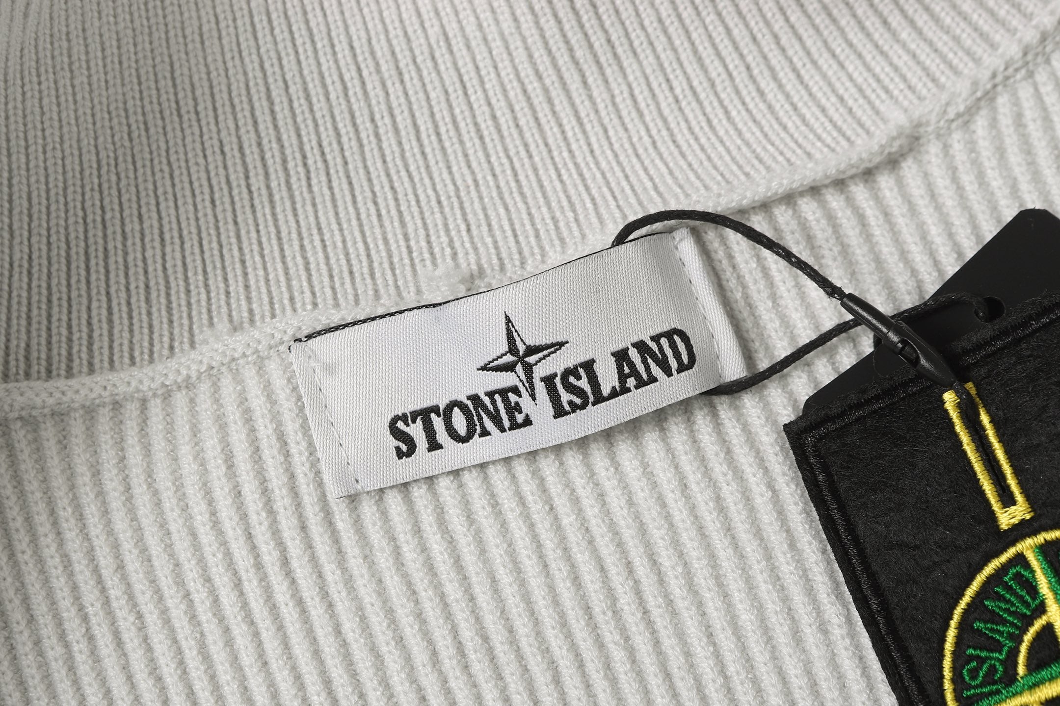 Stone Island knit jacket inner label and black brand tag