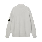 Light gray knit jacket with stand collar, ribbed cuffs, and sleeve patch