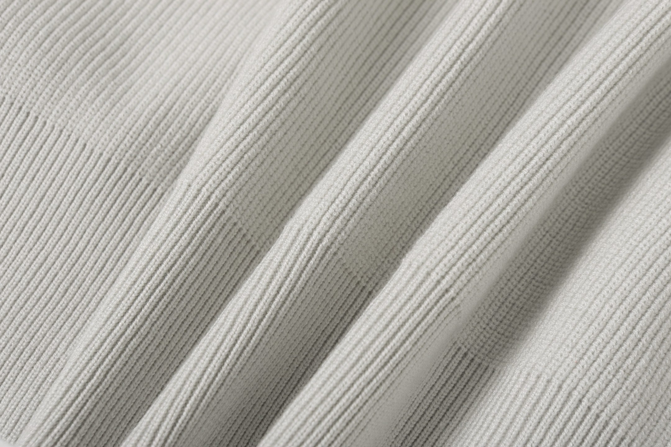 Light gray ribbed knit fabric panel detail on jacket sleeve