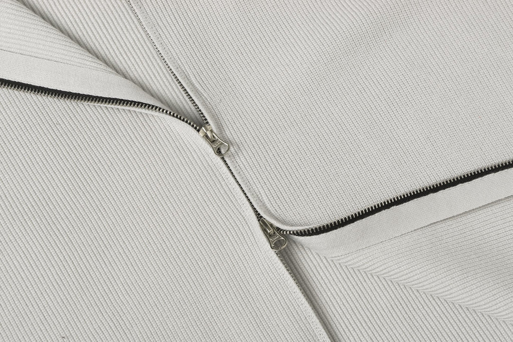 Light gray knit jacket front zipper with metal pull and stitched placket