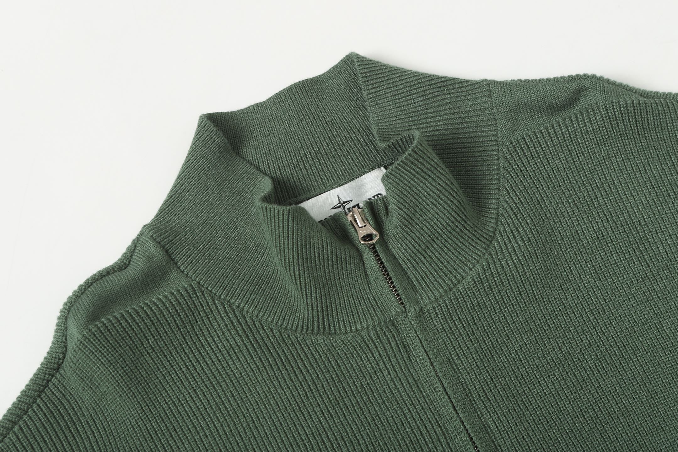 Stone Island zip jacket collar detail in dark green rib-knit with zipper pull