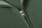 Stone Island dark green zip jacket close-up of metal zipper and rib-knit texture