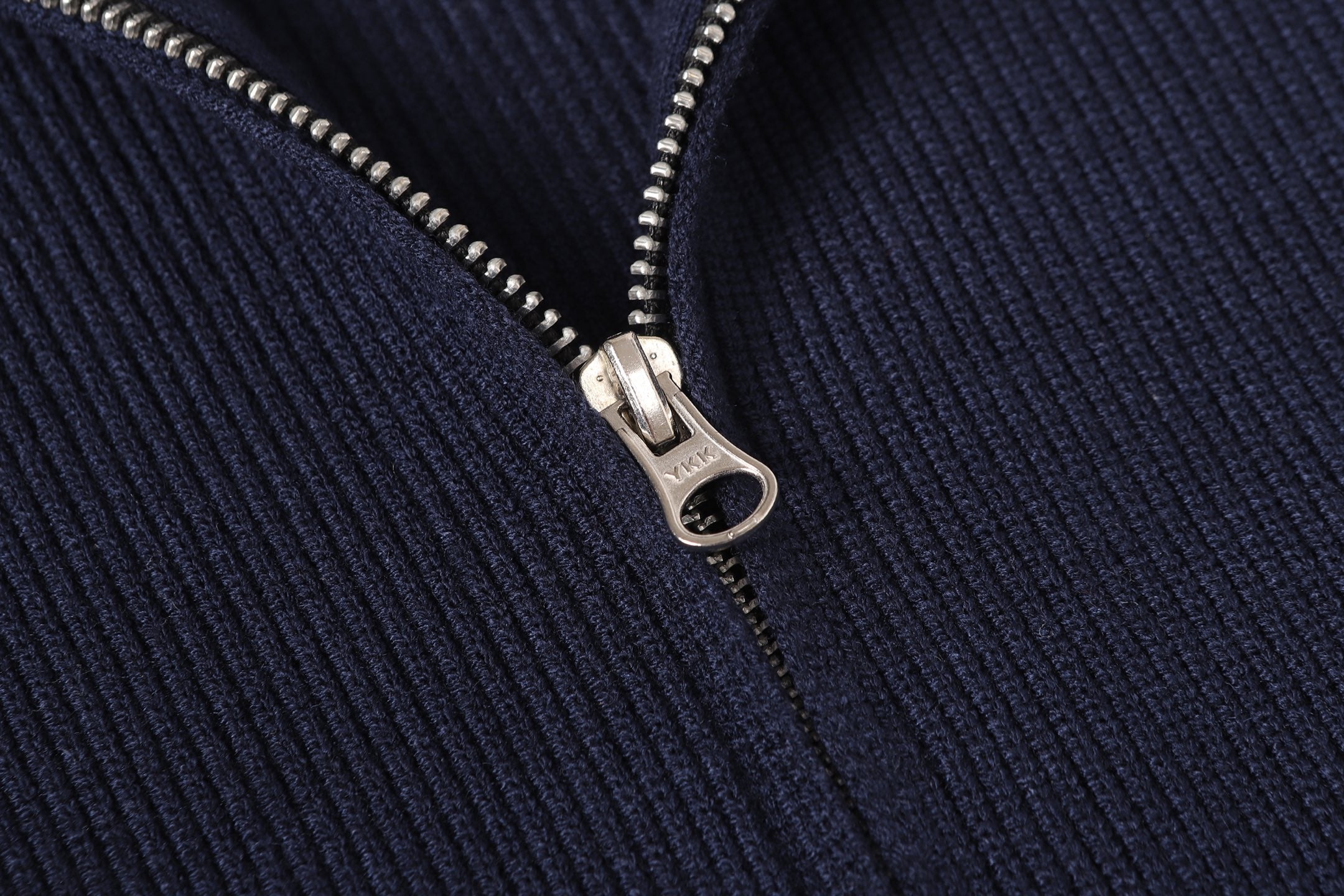 Stone Island metal zipper detail on dark navy knit jacket