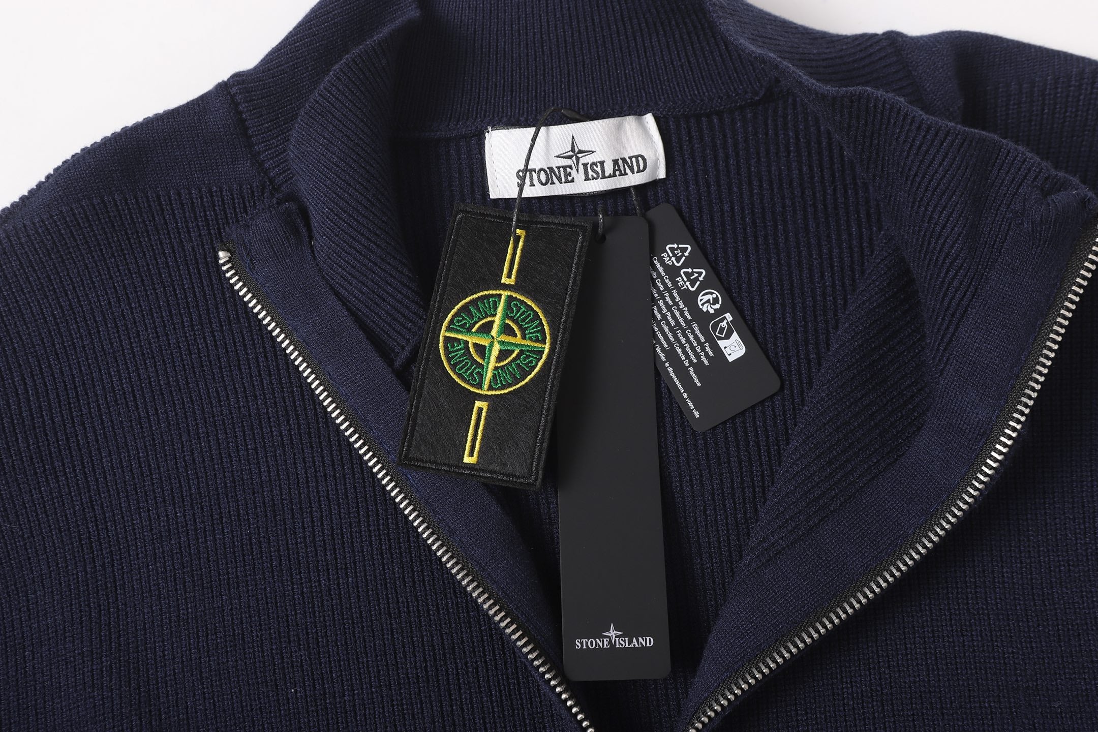 Stone Island knit zip jacket front with logo patch and silver zip pull, dark navy