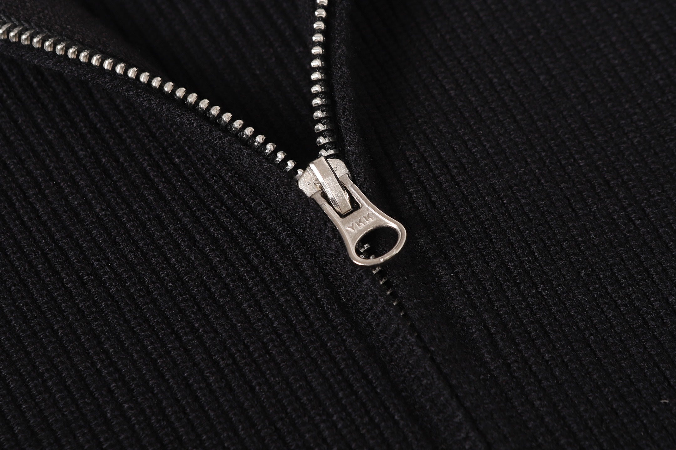 Stone Island black jacket zipper close-up with silver pull