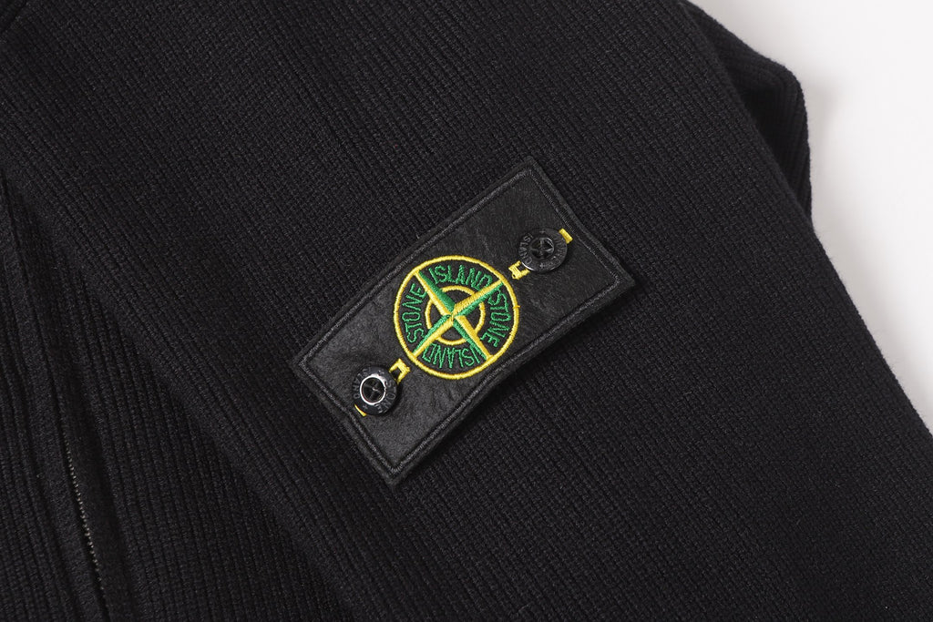Stone Island black jacket chest emblem patch on dark fabric
