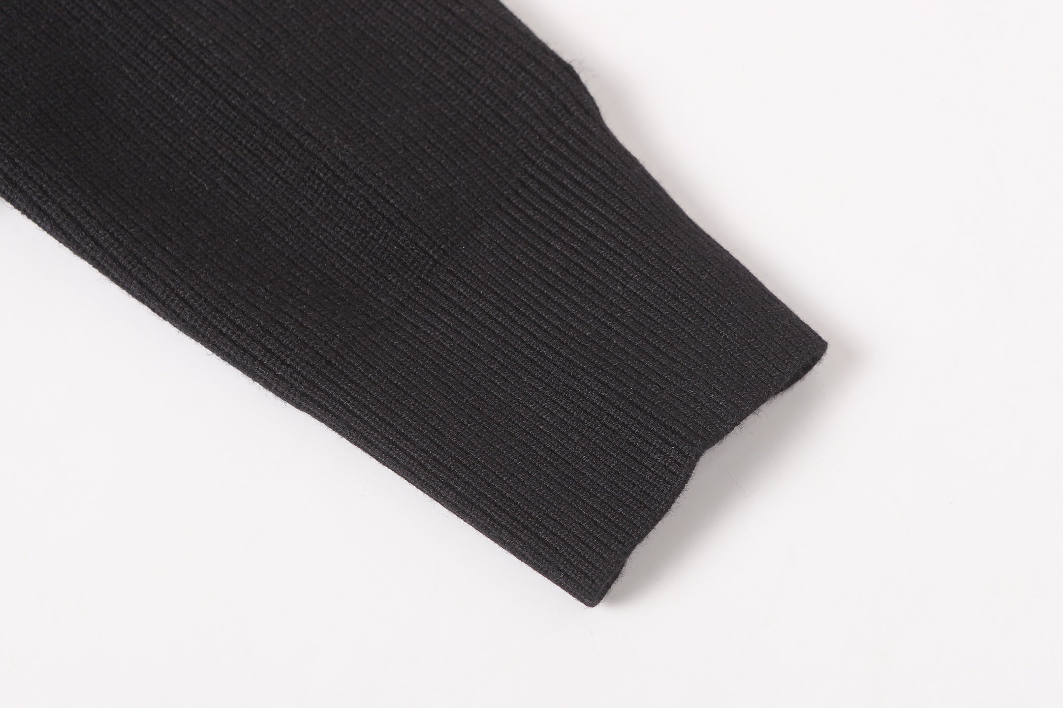 Stone Island black jacket sleeve cuff close-up with ribbed hem