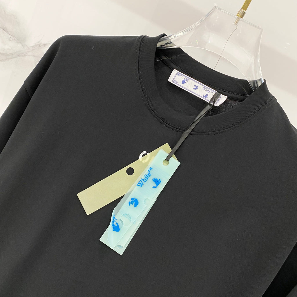 Black T-shirt with OFF logo and hanging brand tag at neckline