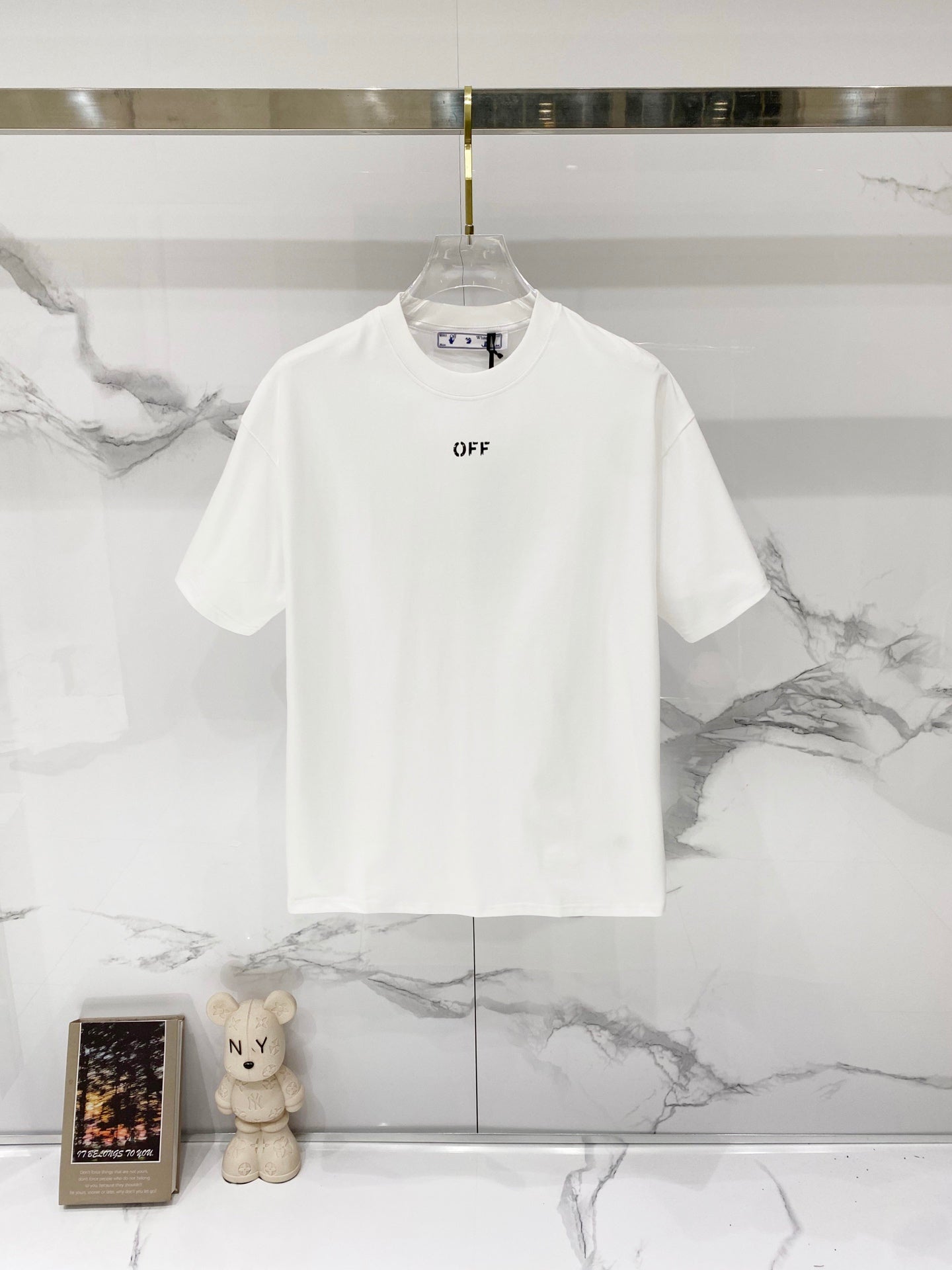 Off-white T-shirt with small black OFF logo on chest