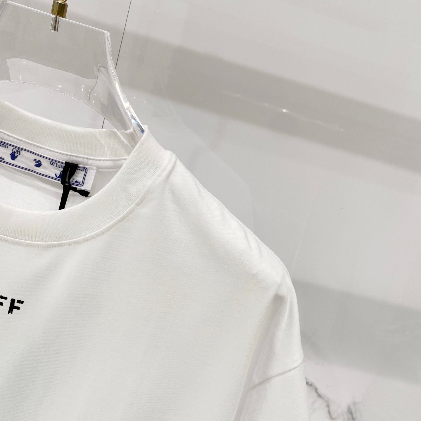 Off-white T-shirt collar with internal brand label and tag
