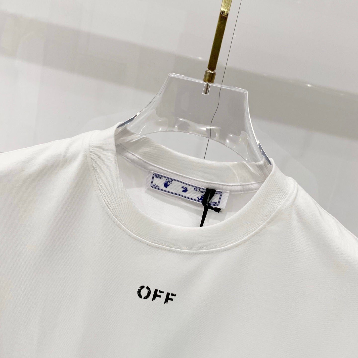 Off-white T-shirt neckline with brand tag inside collar