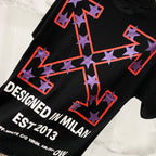 Off-White black T-shirt with large star-arrow graphic and "DESIGNED IN MILAN" text