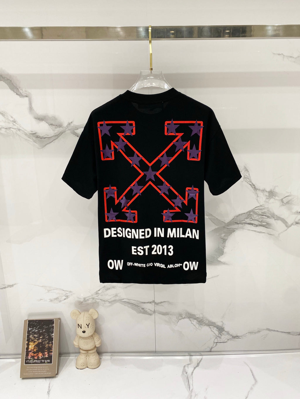 Off-White black T-shirt with red star graphic and "DESIGNED IN MILAN" text