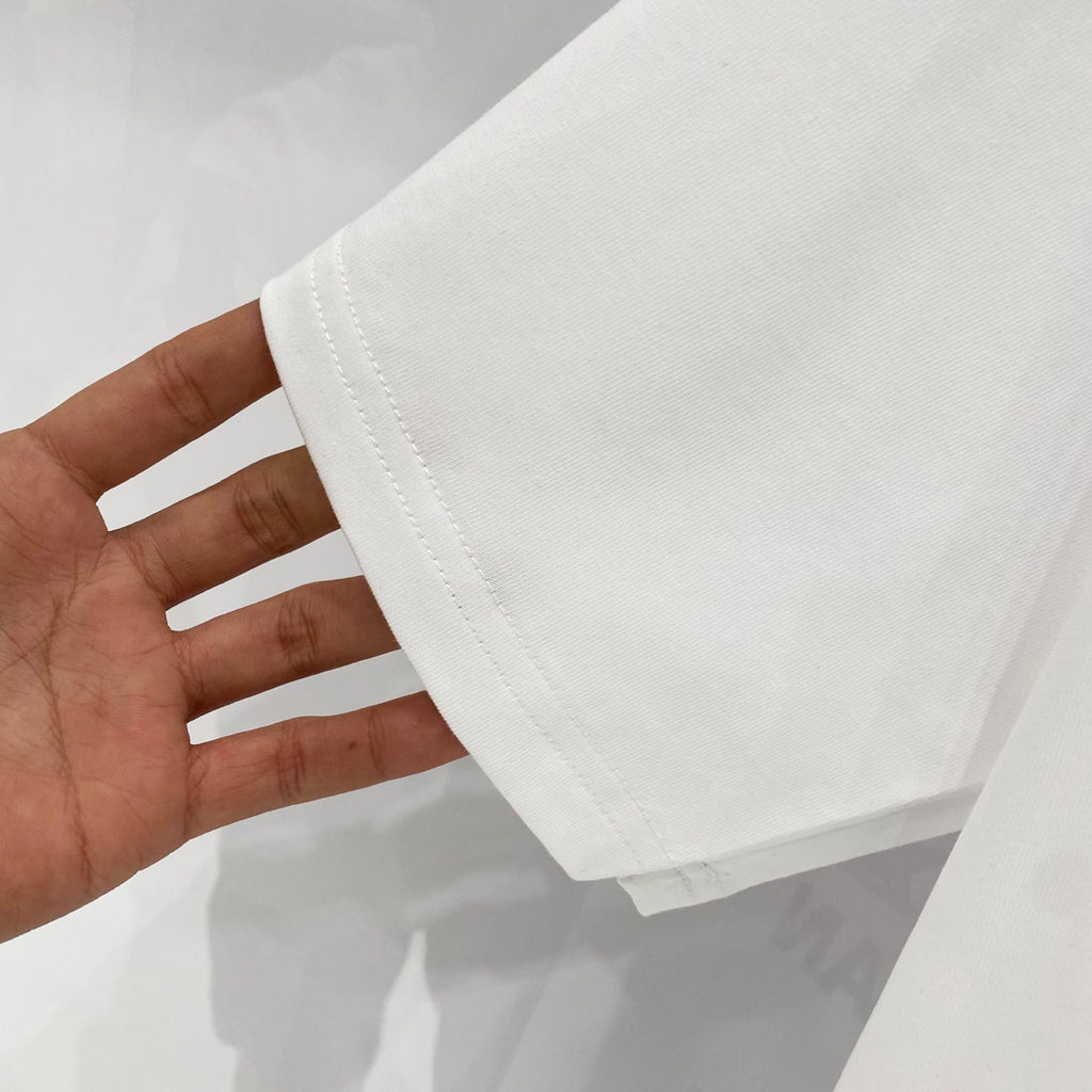 White T-shirt fabric hem with visible stitching detail