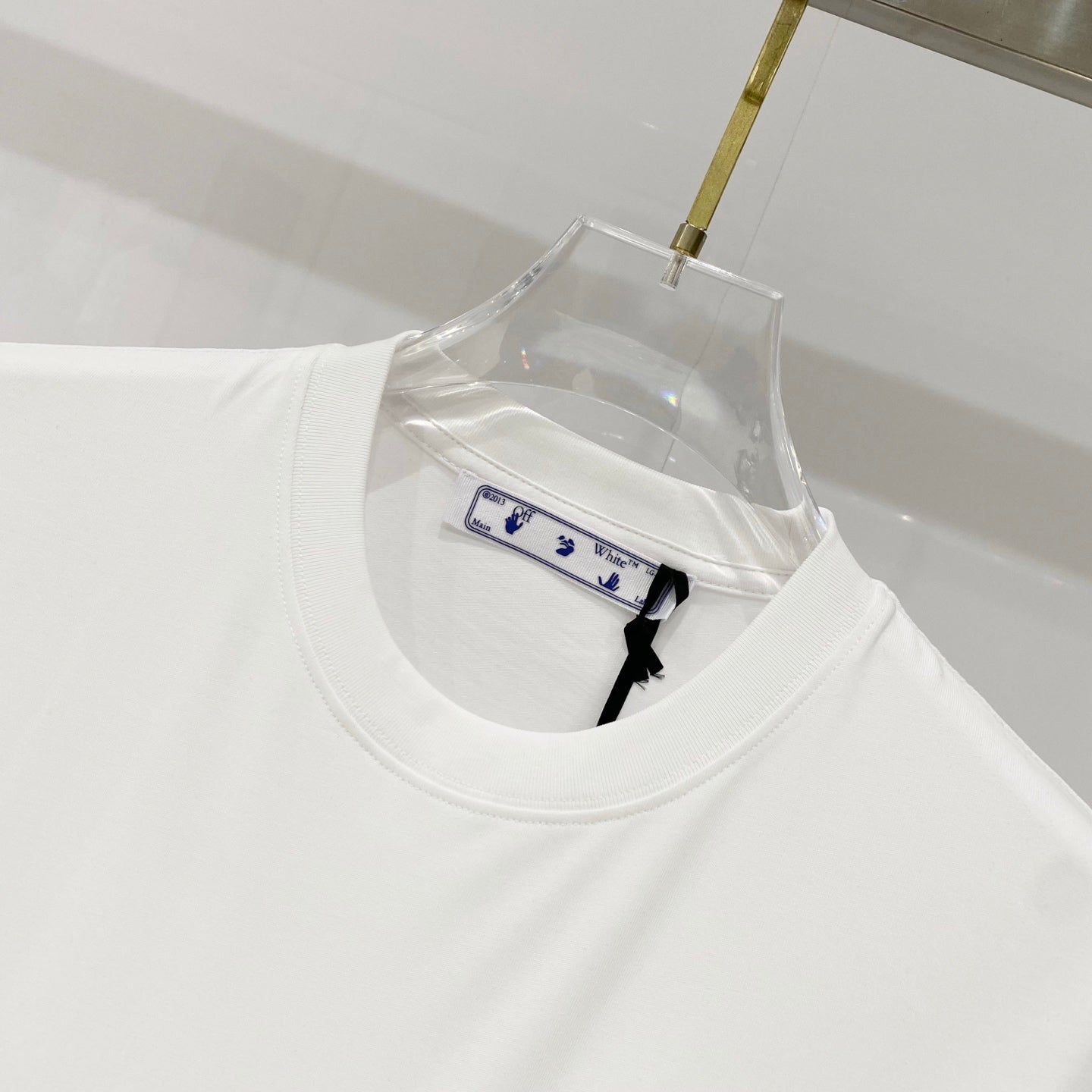 White T-shirt neckline with inner label and clear hang tag