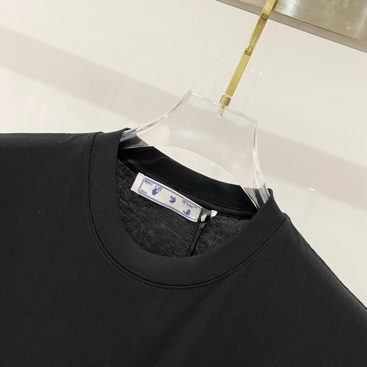 Off White black T-shirt neckline close-up with inner brand label