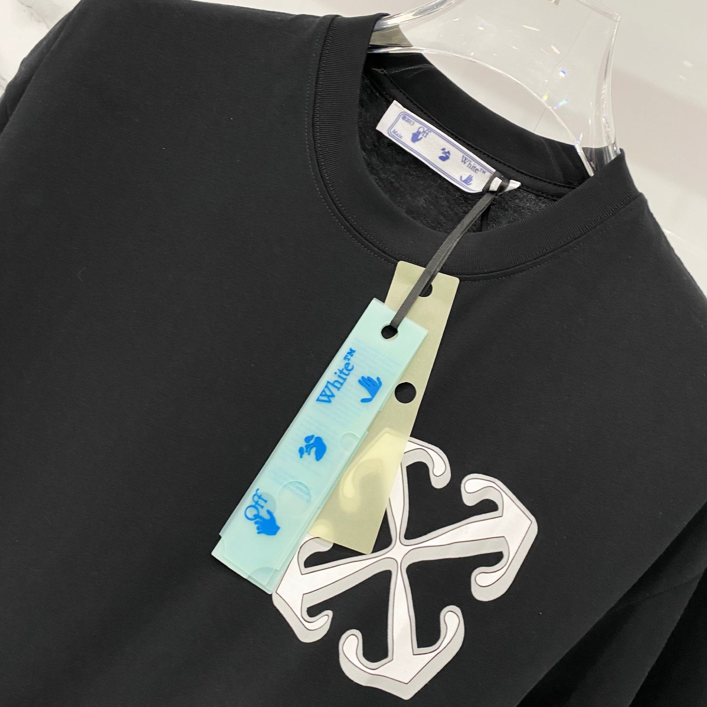 Off White black T-shirt collar close-up with hanging size tag