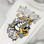 Off-white T-shirt close-up of bold dragon graphic and stars