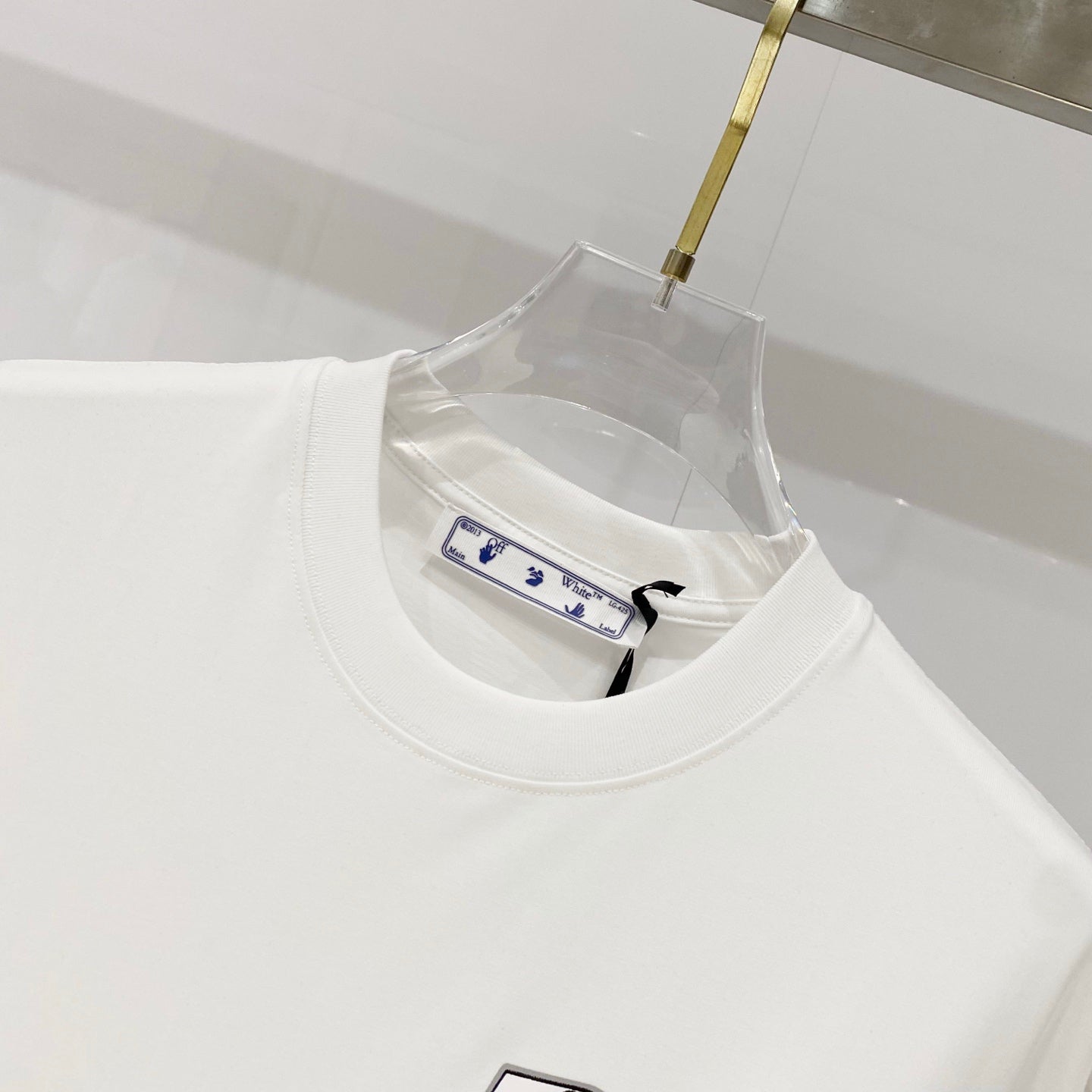 Off-white T-shirt neckline close-up with inner neck label