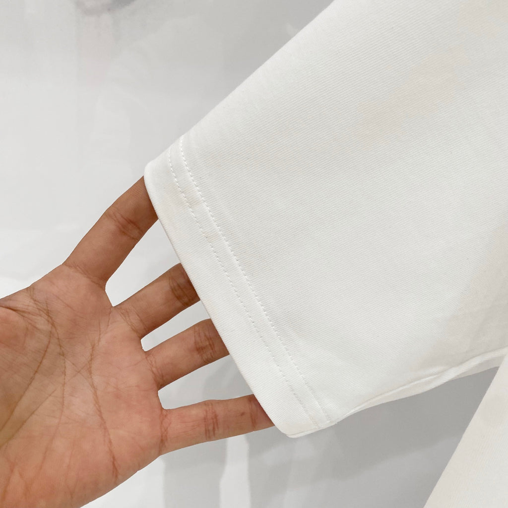 Off-white T-shirt sleeve hem close-up with stitched cuff